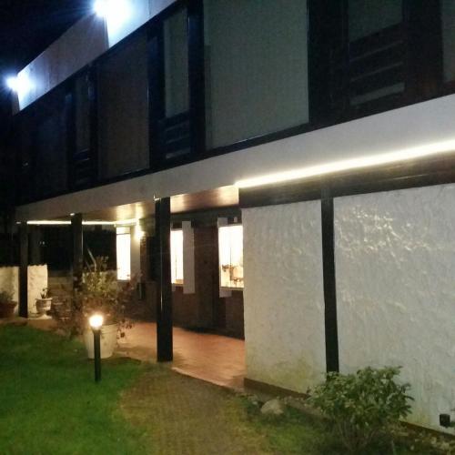 a lit up building at night with lights on it at Am Hallenbad Hotel garni in Ratingen