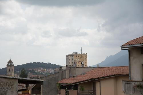 a city with buildings and a mountain in the background at B&B Annalu' in Guspini