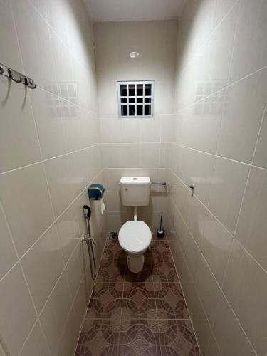 a small bathroom with a toilet and a window at Raub homesty in Raub