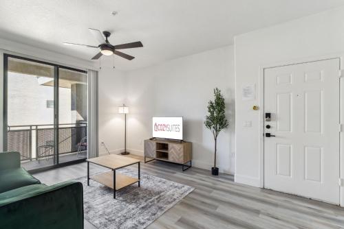 a living room with a couch and a flat screen tv at CozySuites Glendale - Westgate with pool 06 in Glendale