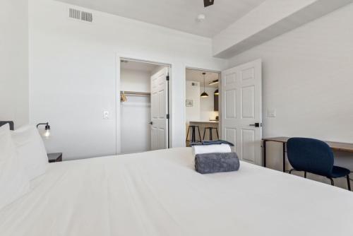 a bedroom with a large white bed and a desk at CozySuites Glendale - Westgate with pool 05 in Glendale