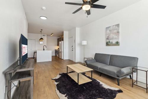 a living room with a couch and a table at CozySuites Glendale - Westgate with pool 05 in Glendale