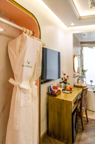 a dress hanging on a rack in a room at Mai Hotel in Hanoi