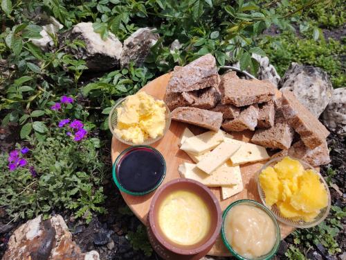 a plate of cheese and crackers and two bowls of dip at Fortress House Khakhabo in Khakhabo