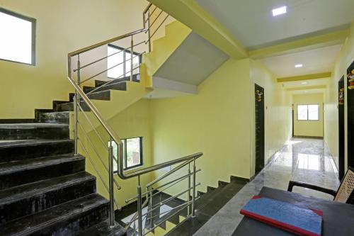 eine Wendeltreppe in einem Raum mit grünen Wänden in der Unterkunft Hotel Om Sai residency in Taloje