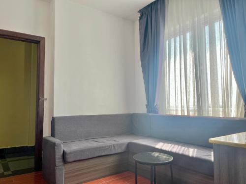 a living room with a couch and a window at Kep Sea View Hotel & Sky Bar in Kep
