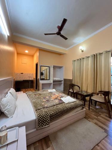 a bedroom with a bed and a ceiling fan at Vacation home in Dharmsala