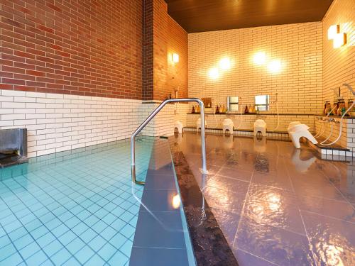 a large pool of water in a building at LiVEMAX RESORT Izukogen Annex in Ito