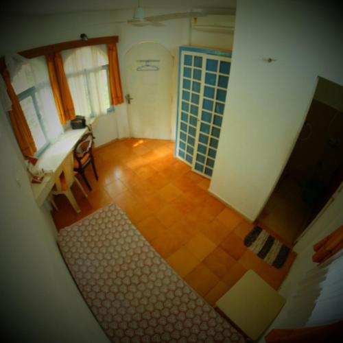 a view of a room with a table and a bathroom at New Creation Guest House in Auroville