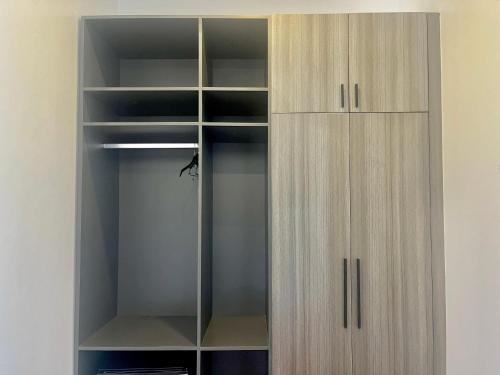 a wooden wardrobe with glass doors in a room at Kep Sea View Hotel & Sky Bar in Kep