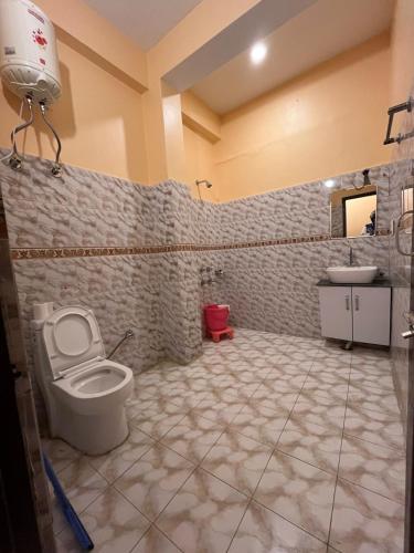 a bathroom with a toilet and a sink at Vacation home in Dharmsala