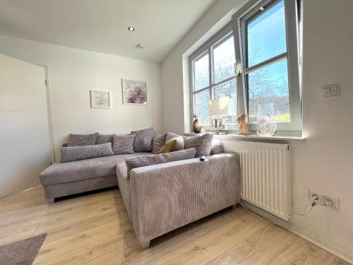 a living room with a couch and a window at Balance Apartments by M&A - Family Apartment Ferienhaus Dohrenbach in Witzenhausen