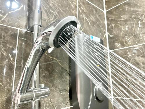 a chrome shower faucet in a bathroom at Kep Sea View Hotel & Sky Bar in Kep