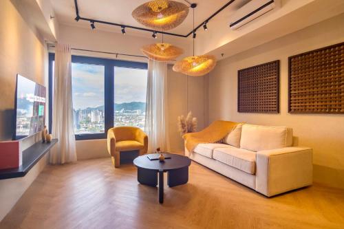 a living room with a couch and a table at ❈ Tropicana 218 by ALV Suites ❈ in George Town