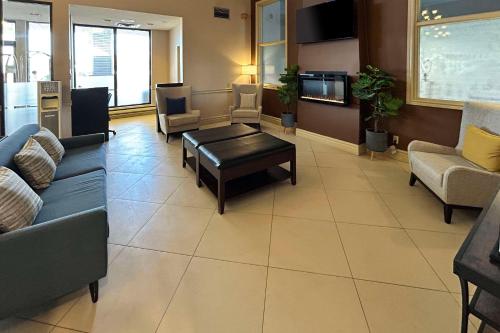 a waiting room with couches and chairs and a table at Comfort Inn & Suites Ambassador Bridge in Windsor