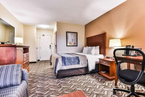 a hotel room with a bed and a desk at Comfort Inn & Suites Ambassador Bridge in Windsor