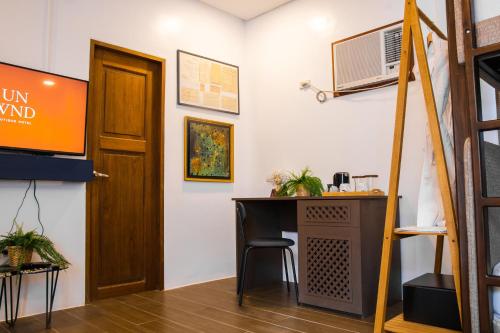 a room with a desk and a door at UNWND Boutique Hotel Calatagan in Batangas City