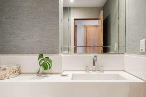 a bathroom with a sink and a mirror at Hilton Copacabana Rio de Janeiro in Rio de Janeiro