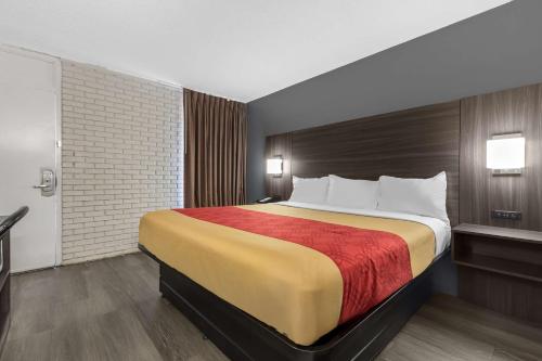 a hotel room with a large bed in it at Econo Lodge in Creedmoor