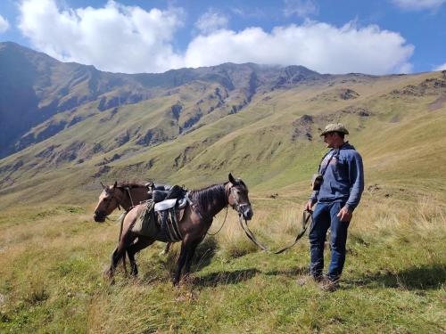 a man with a horse on a hill at Fortress House Khakhabo in Khakhabo