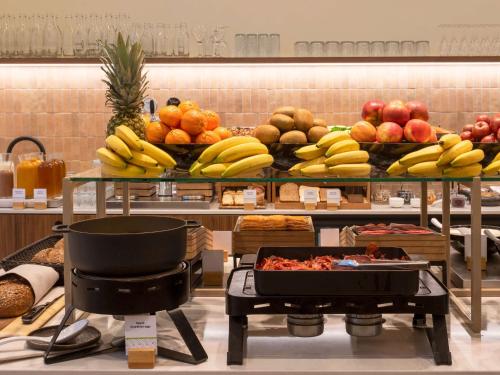 a buffet of fruits and vegetables on display in a store at DoubleTree by Hilton Sittard in Sittard