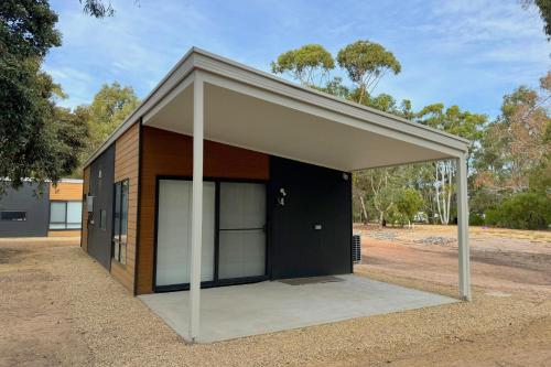 a small building with a large garage at The Cabins at Douglas Scrub in Blewitts Springs