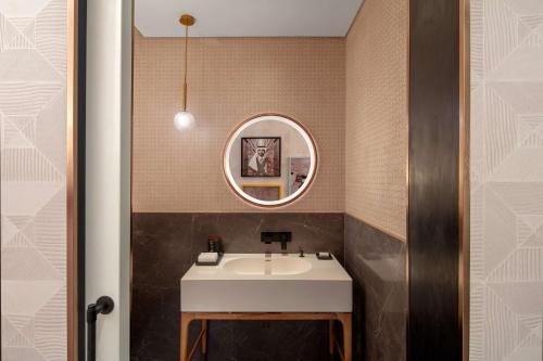 a bathroom with a sink and a mirror at Andaz Doha, by Hyatt in Doha