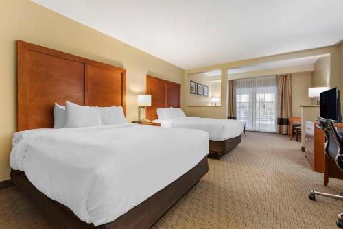 a hotel room with two beds and a television at Comfort Inn & Suites Black River Falls I-94 in Black River Falls