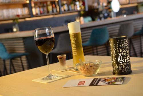 a glass of wine and a bottle of champagne on a table at Sure Hotel by Best Western Hilden-Düsseldorf in Hilden