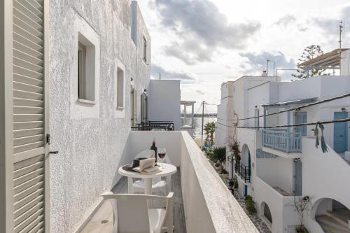 a balcony with a table and chairs on a building at Azur Playa Naxos in Naxos Chora