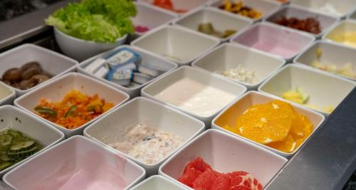 a bunch of white plates with different types of food at Sure Hotel by Best Western Hilden-Düsseldorf in Hilden
