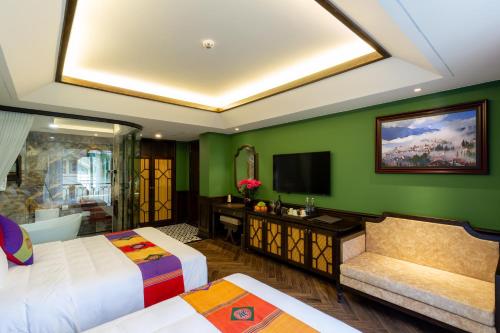 a hotel room with two beds and a television at Fansipan View Hotel in Sa Pa
