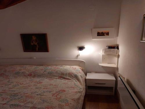 a small bedroom with a bed and a night stand at Holiday Home Kamenice - One Bedroom Holiday Home with Terrace in Gruda