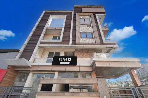 a tall building with a mitzo sign on it at Super Hotel O GMS Road Near Bus Stand in Dehradun