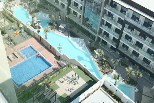 an overhead view of an apartment complex with a swimming pool at Casa Royale Vacation Home - JVC in Dubai