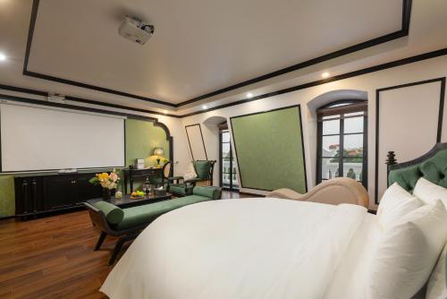 a bedroom with a large bed and a projection screen at Royal Hotel Vinh Yen in Nhân Mỹ