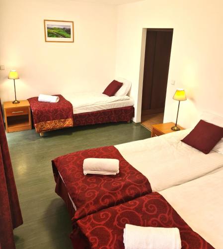 a hotel room with three beds in a room at Ośrodek Trzy Korony Krościenko nad Dunajcem in Krościenko