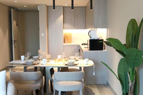 a dining room table and chairs in a kitchen at Casa Royale Vacation Home - JVC in Dubai