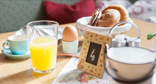 a table with eggs and a glass of orange juice at Gästezimmer Frühwirth in Teesdorf
