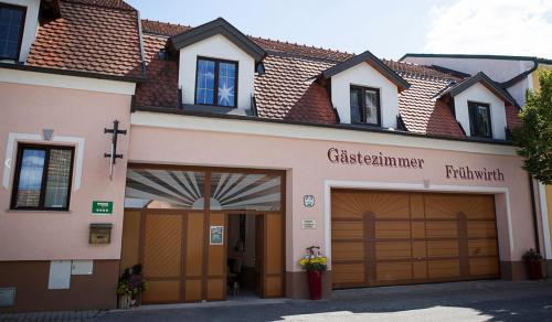 a building with two garage doors and a church at Gästezimmer Frühwirth in Teesdorf