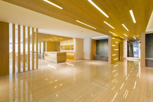 an empty lobby with wood floors and a room at Zenniq in Bangkok