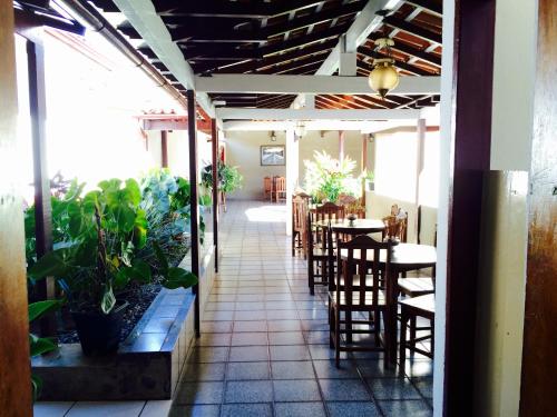 a restaurant with tables and chairs and a patio at Hotel Priskar in Ouro Preto