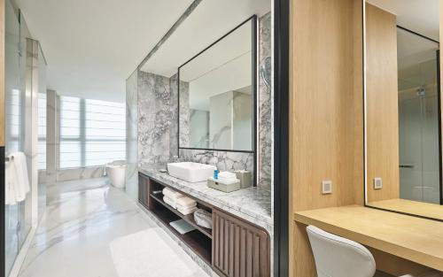 a bathroom with a sink and a mirror at Grand Ocean View Hotel Zhuhai in Zhuhai