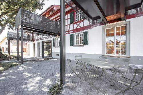 a table and chairs in front of a building at Camping Wagenhausen in Wagenhausen
