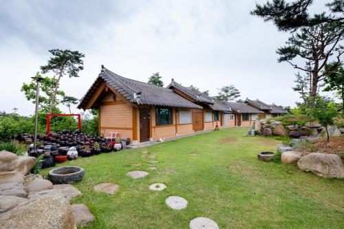 a house with a lot of pots in front of it at Yangyang Cheongjong Healing Forest Pension in Chan'gyo-ri