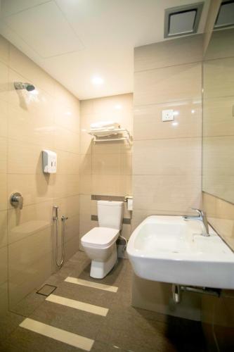 a bathroom with a toilet and a sink and a tub at 33 Boutique Hotel Bandar Sunway in Petaling Jaya