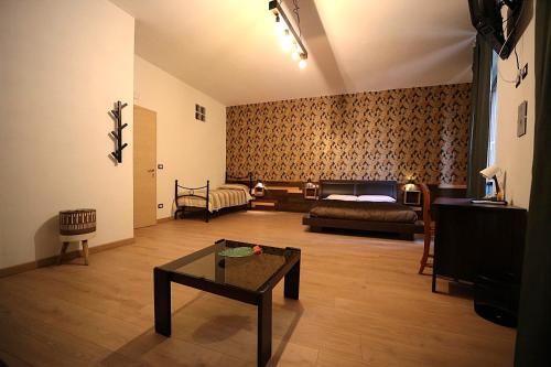 a living room with a bed and a coffee table at Camurria Sicilian B&B in Piazza Armerina