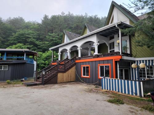 a house with an orange and white at Pyeongchang Pension Dorothy in Pyeongchang 