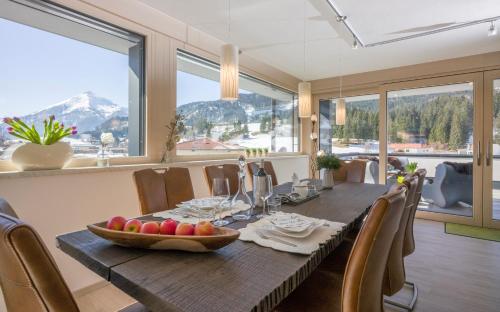 a dining room with a table with a bowl of fruit on it at Ledermaier Loft & Lodge`s eU in Achenkirch