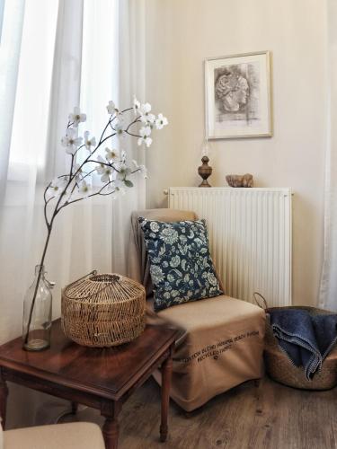 a living room with a chair and a table at La Casa Buranella in Lefkada